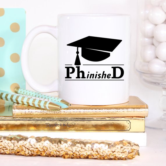 PhinisheD 11oz Coffee Mug featuring a humorous design, perfect for coffee lovers and graduates.